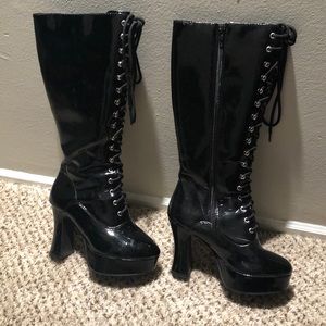 Black lace up boots w/ side zipper. 4” heel.